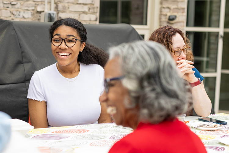 students laughing at table during meal